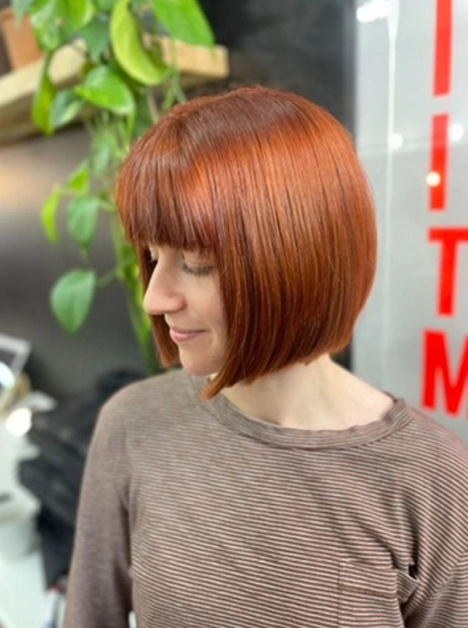 Glossy copper bob with a full fringe