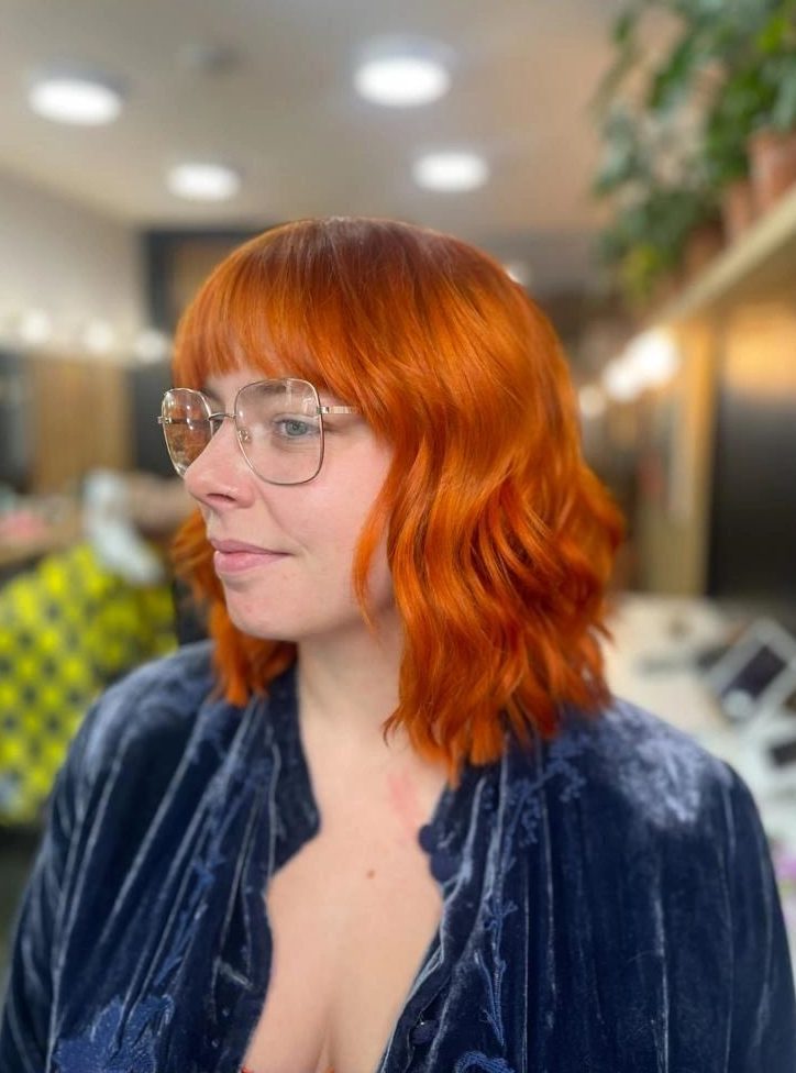Bright copper bob with a curtain fringe, finished with loose waves