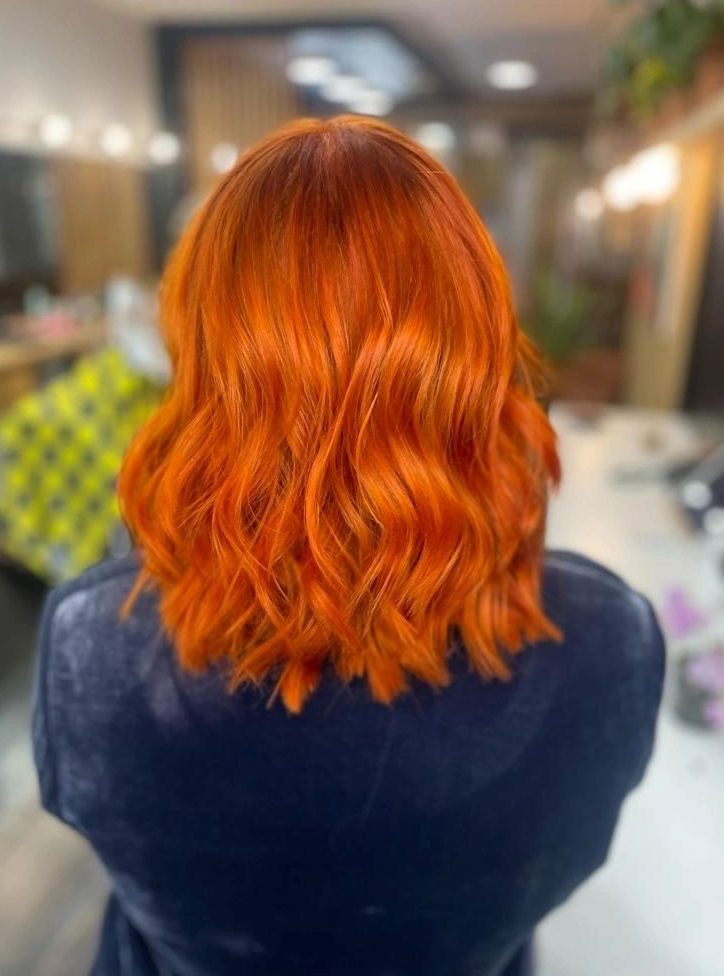 Bright copper bob from behind, with loose waves